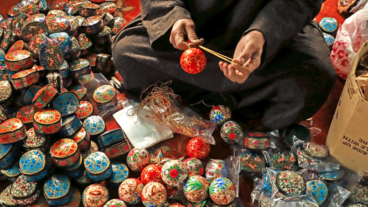 An artisan works on a papier-mache item ahead of Christmas, at his workshop in Srinagar (Pic: PTI)