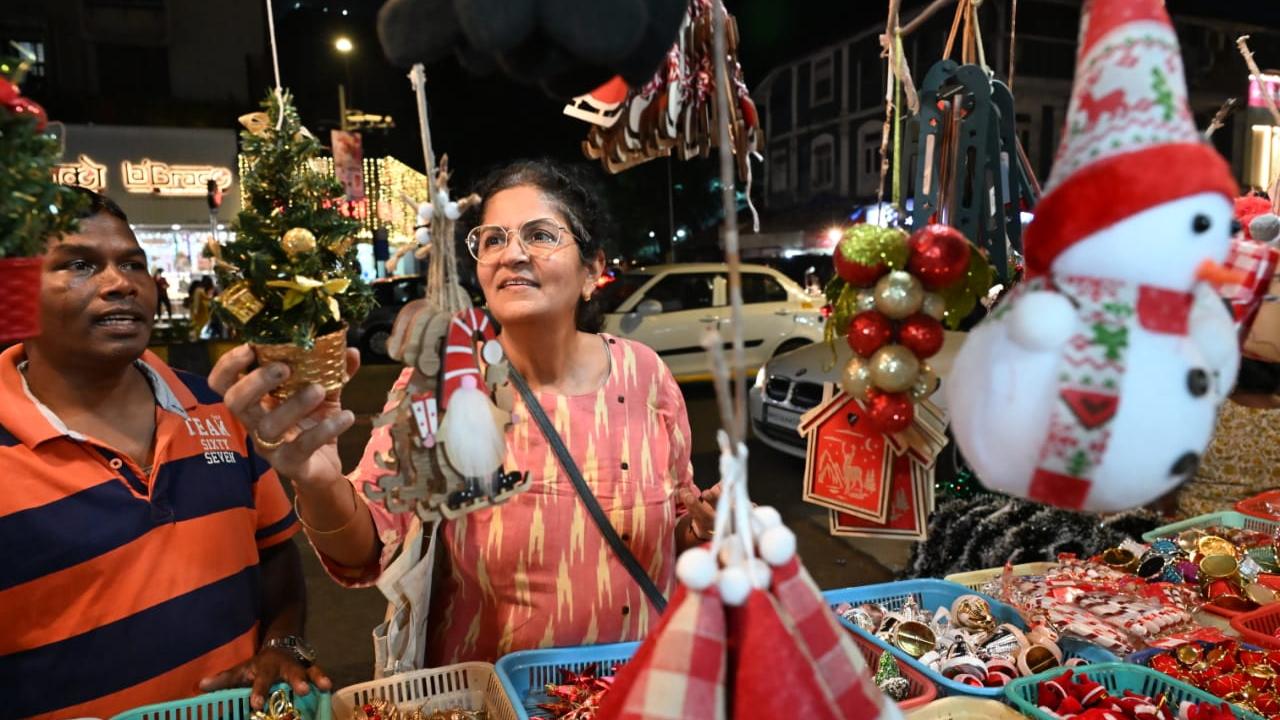 In Pic: A customer looks at a unique decor item -- a mini Christmas tree