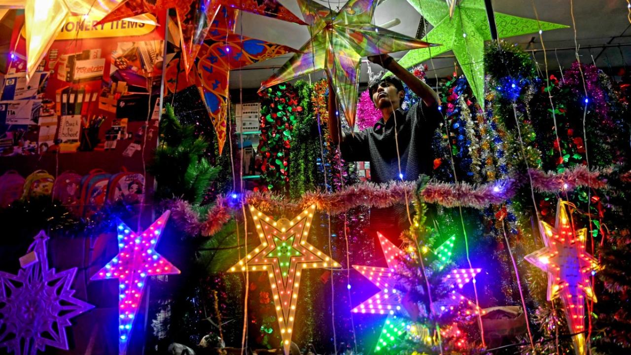 A man arranges Christmas decor at a shop in Chennai (Pic: AFP)