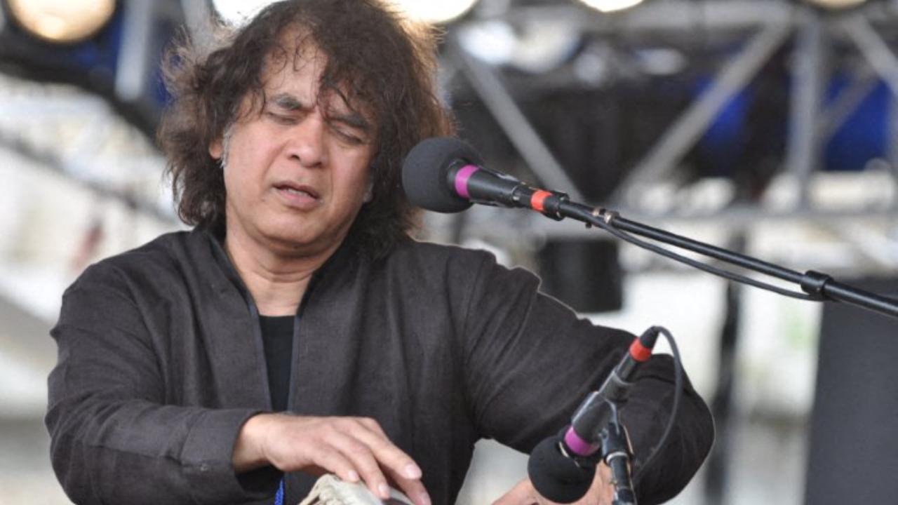 Zakir Hussain performs with reed player Charles Lloyd and drummer Eric Harland on 7 August, 2011 on the main stage in Newport, Rhode Island during the 2011 Newport Jazz Festival