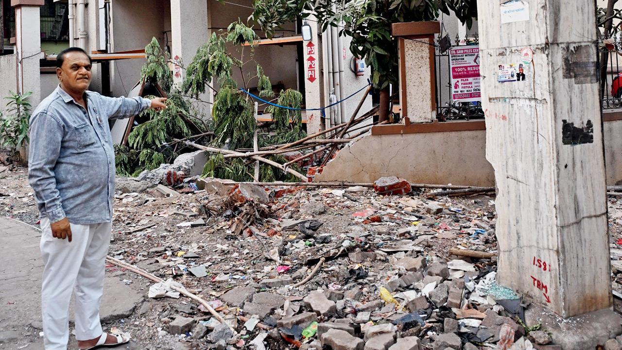 Narrow road cluttered with debris, illegal parking left little space to escape