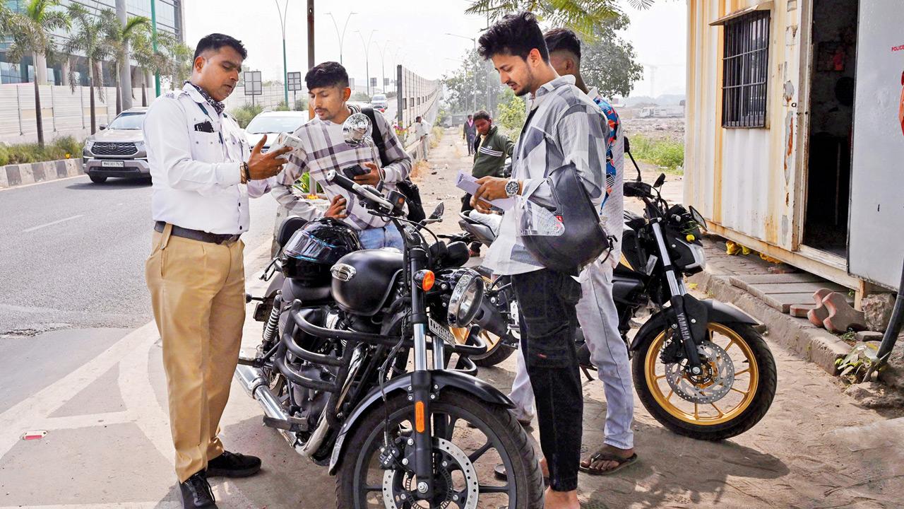 Bikers are fined after crossing over from Chunabhatti to BKC via the connector, which is strictly for four-wheelers, on Sunday. Pics/Atul Kamble