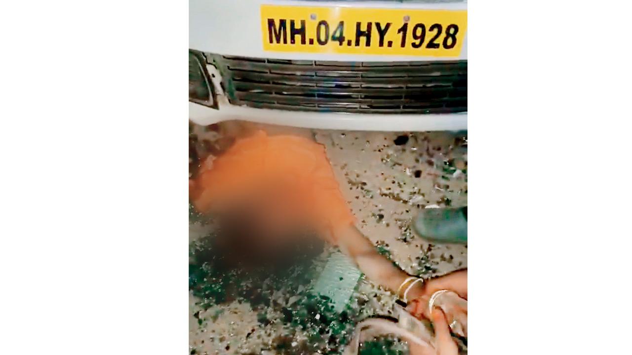 Screengrab of the viral video showing the man in helmet removing gold bangles from the dead body’s hand