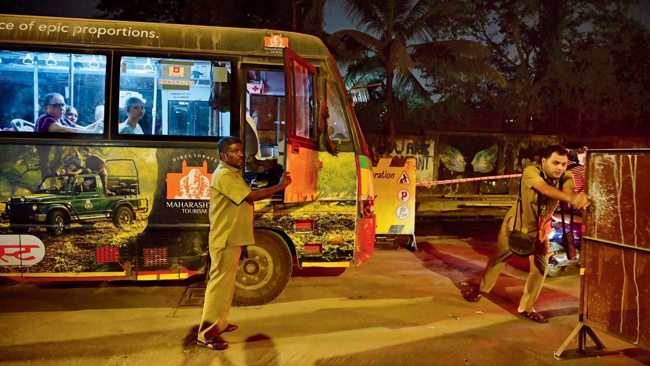 BEST staff move barricades and try manage traffic on Kanti Park Road, on Tuesday