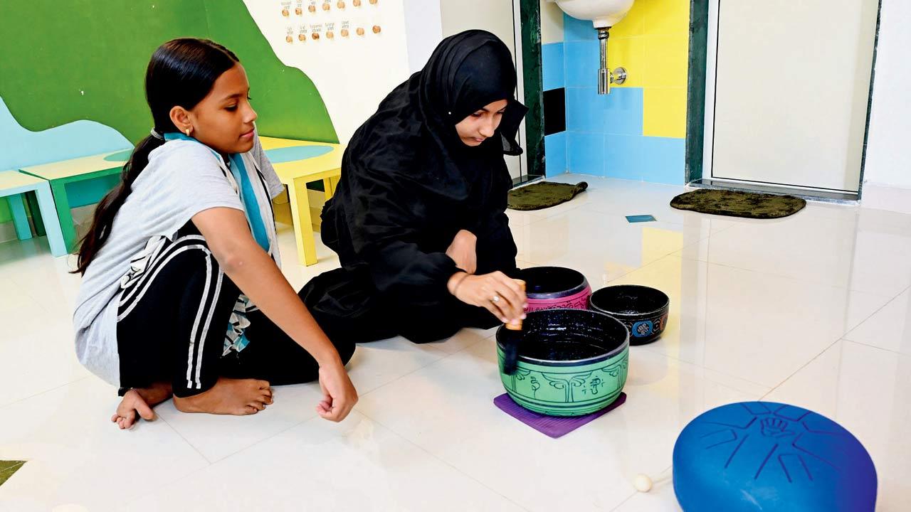 Children play a sound bath during a healing session at Humraahi