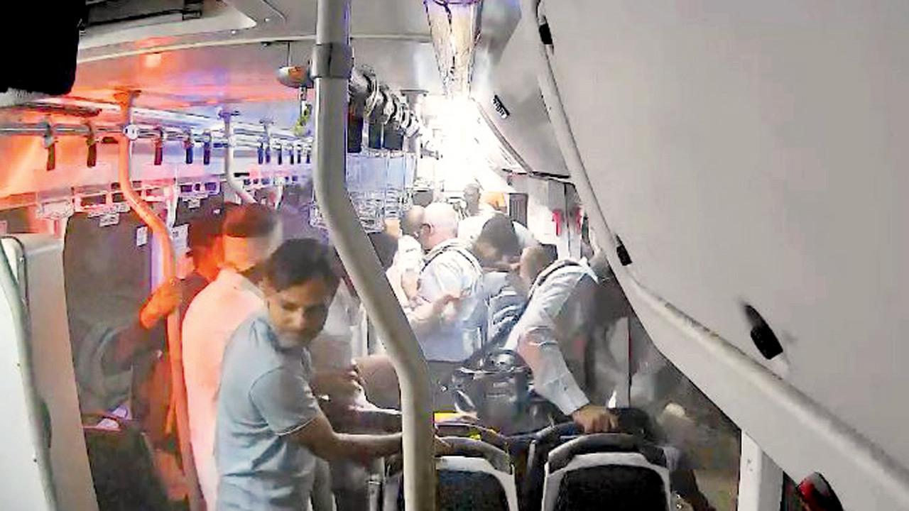 Passengers jump off the bus after it crashes into a wall