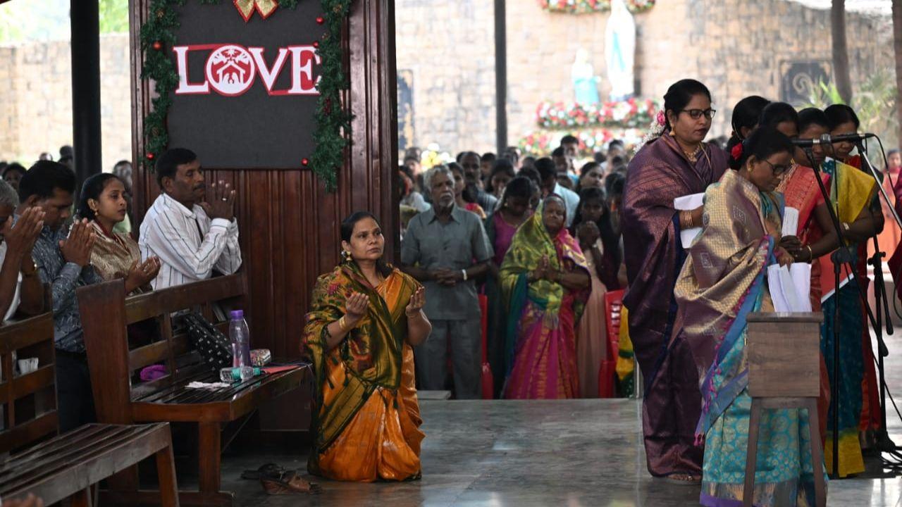 A devotee kneels before the statue of Jesus Christ, offering prayers and seeking blessings on this holy occasion