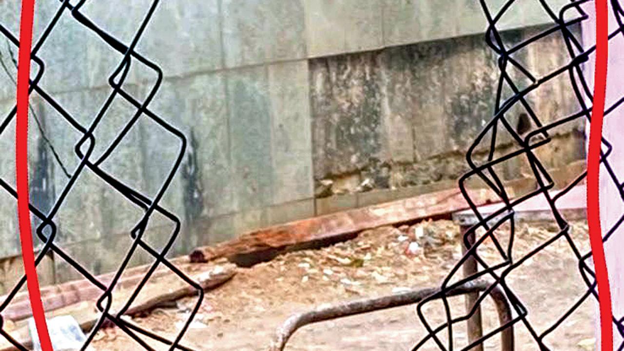 Damaged fence that provides illegal access to slums