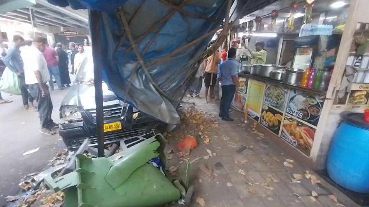 The scene of the crash outside the food stall, where the taxi caused significant damage.