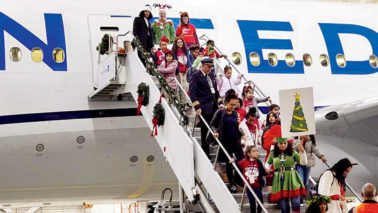 Kids visit Santa in North Pole scene at Denver airport hangar