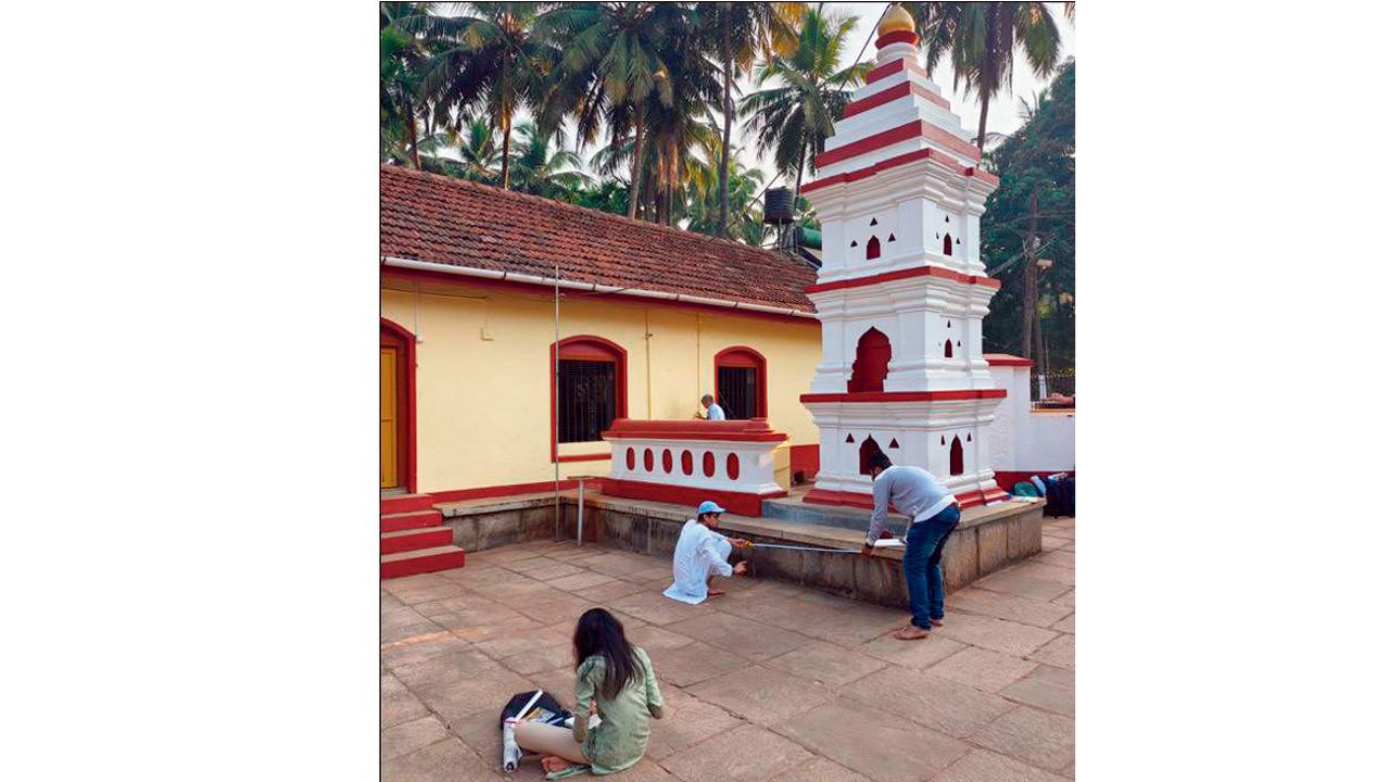 Students document the architecture of a structure in the temple complex