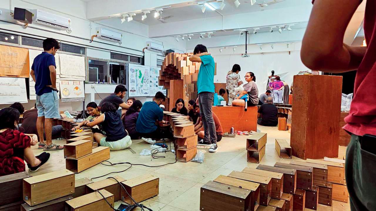 Students work on models of the temples leading up to the exhibition
