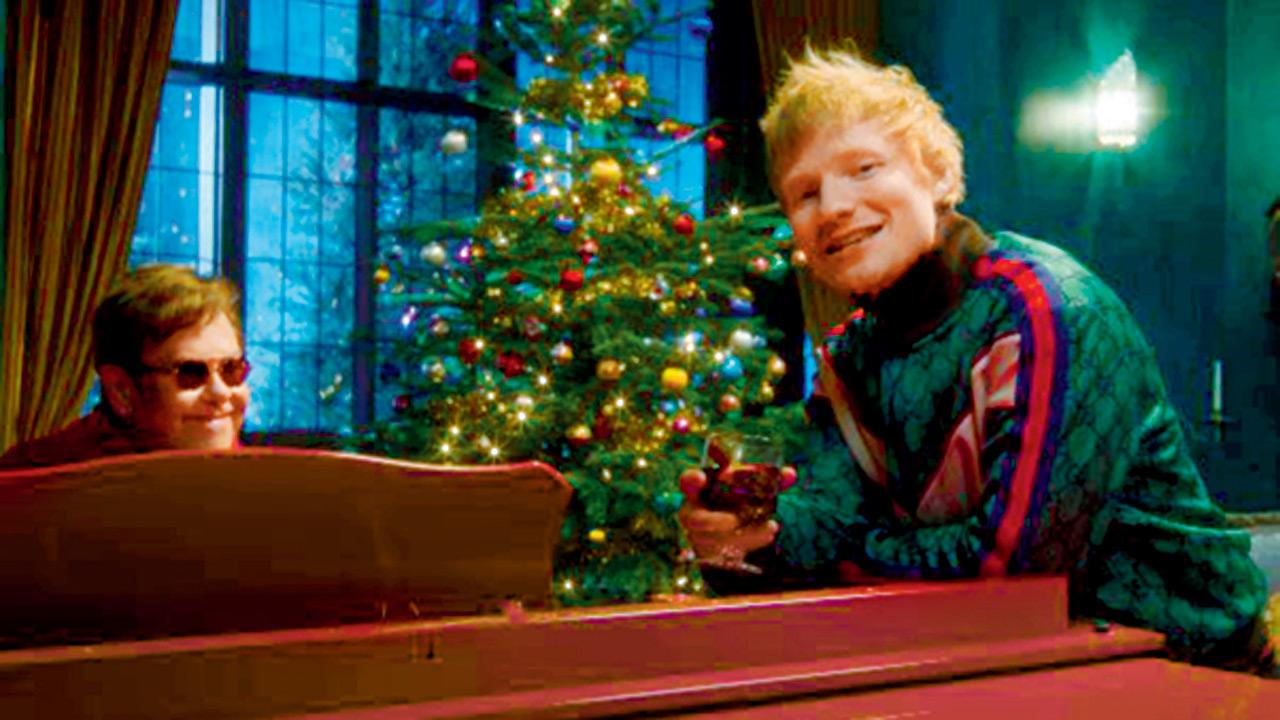 Elton John (left) and Ed Sheeran in the music video of Merry Christmas