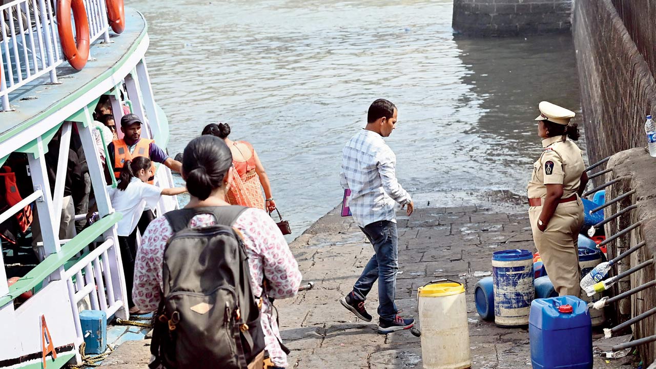 A port authority officer keeps a watch at a jetty at the Gateway of India