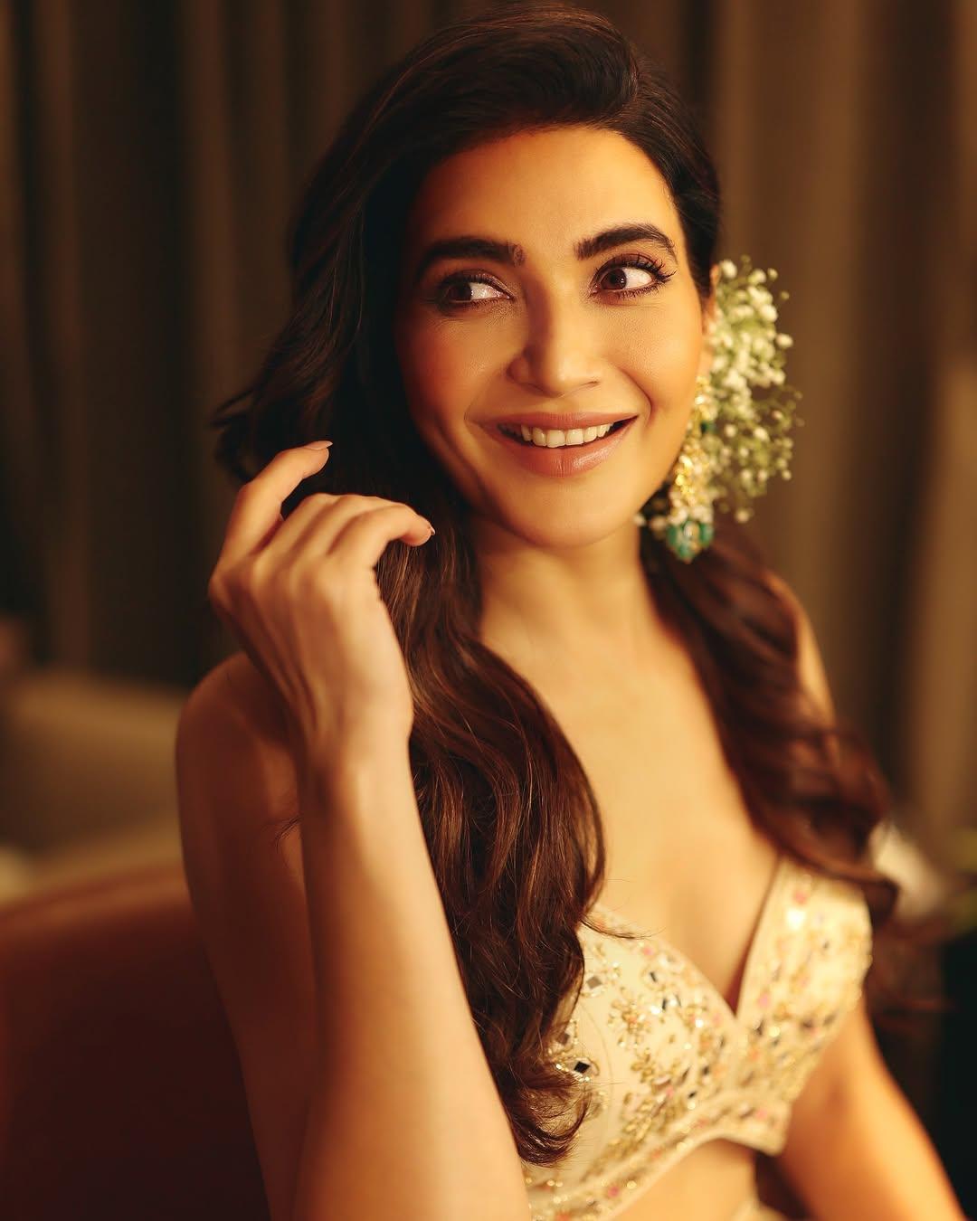This appearance features Karishma looking drop-dead gorgeous as she wore a shiny embroidered beige lehenga paired with a strappy blouse and a sheer, see-through dupatta