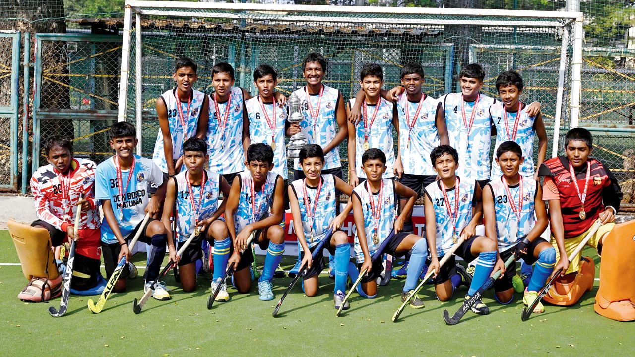 The Don Bosco boys with their trophy and medals at the Don Bosco School ground in Matunga