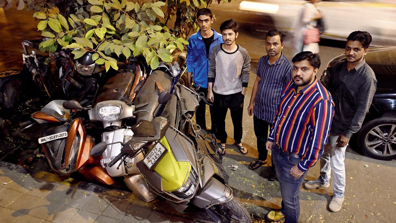 The victims with the badly damaged scooters in Bandra. Pics/Ashish Raje