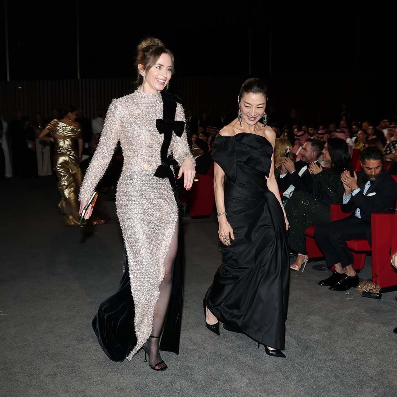 Emily Blunt and Michelle Yeoh snapped in a candid moment at the opening ceremony