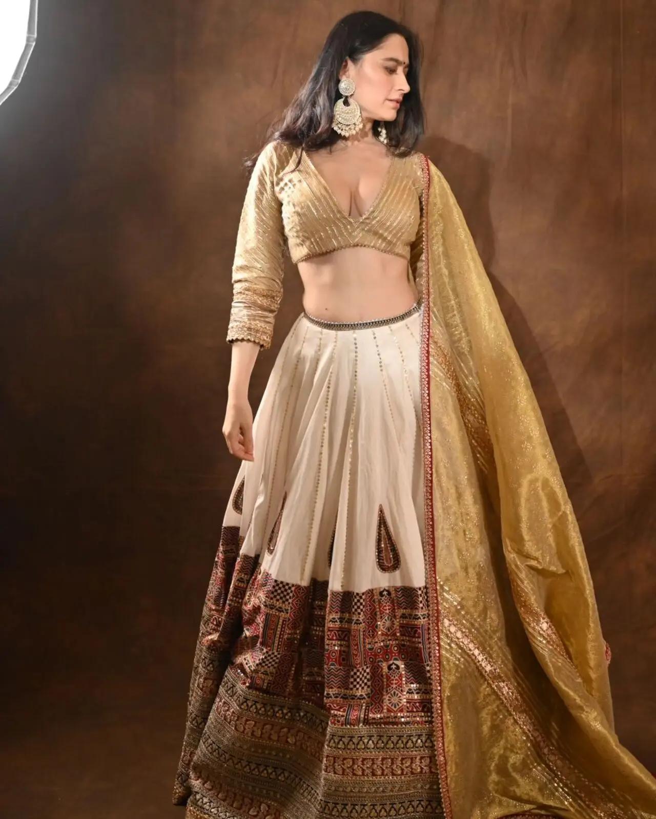The actress wore a golden blouse paired with a matching dupatta and a white lehenga with a printed heavy border. She completed her look by wearing intricately designed big earrings