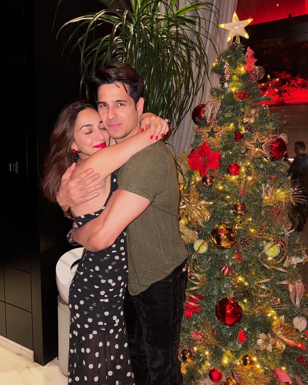 Kiara Advani hugs Sidharth Malhotra during their intimate Christmas celebration. The picture shows Sidharth holding Kiara close as they pose in front of a beautifully decorated Christmas tree.
