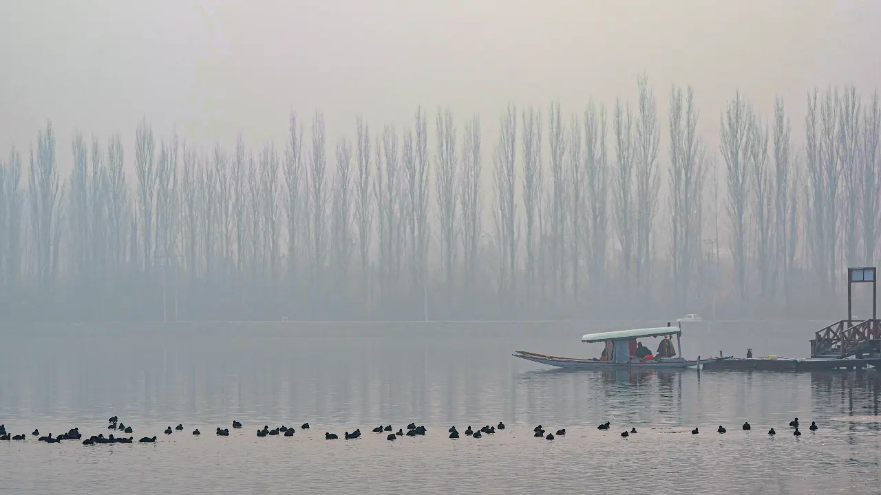 A shikara is seen parked on the banks of the frozen Dal Lake on a cold winter morning, in Srinagar on Saturday as 'Chillai Kalan' saw temperatures dip to the lowest in 50 years, according to the meteorological department.