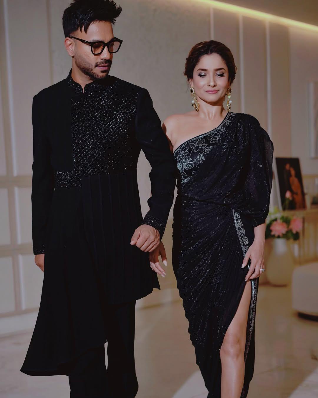 In this picture, Ankita wears a beautiful black gown with a slit, while Vicky Jain looks handsome in a matching outfit.  
