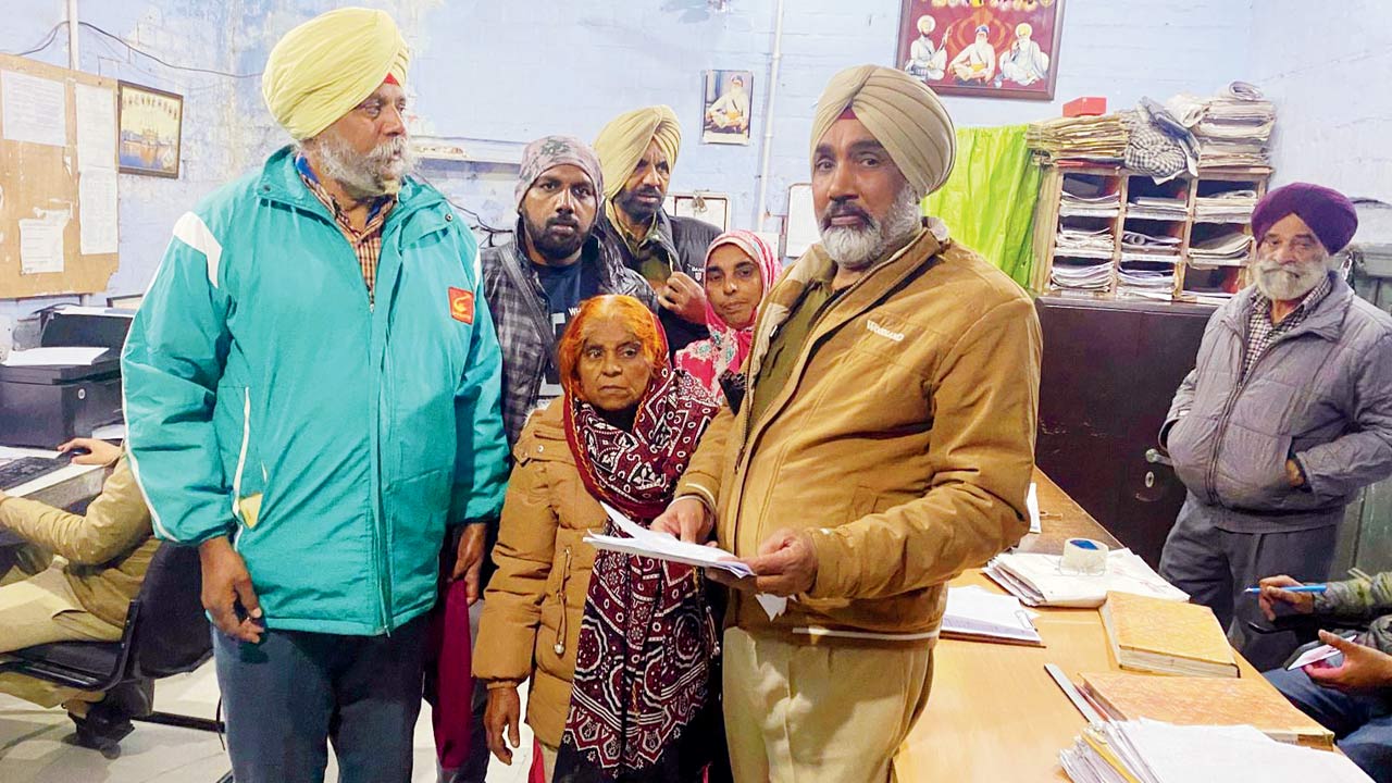 Indian officers at the border process Banu’s documents