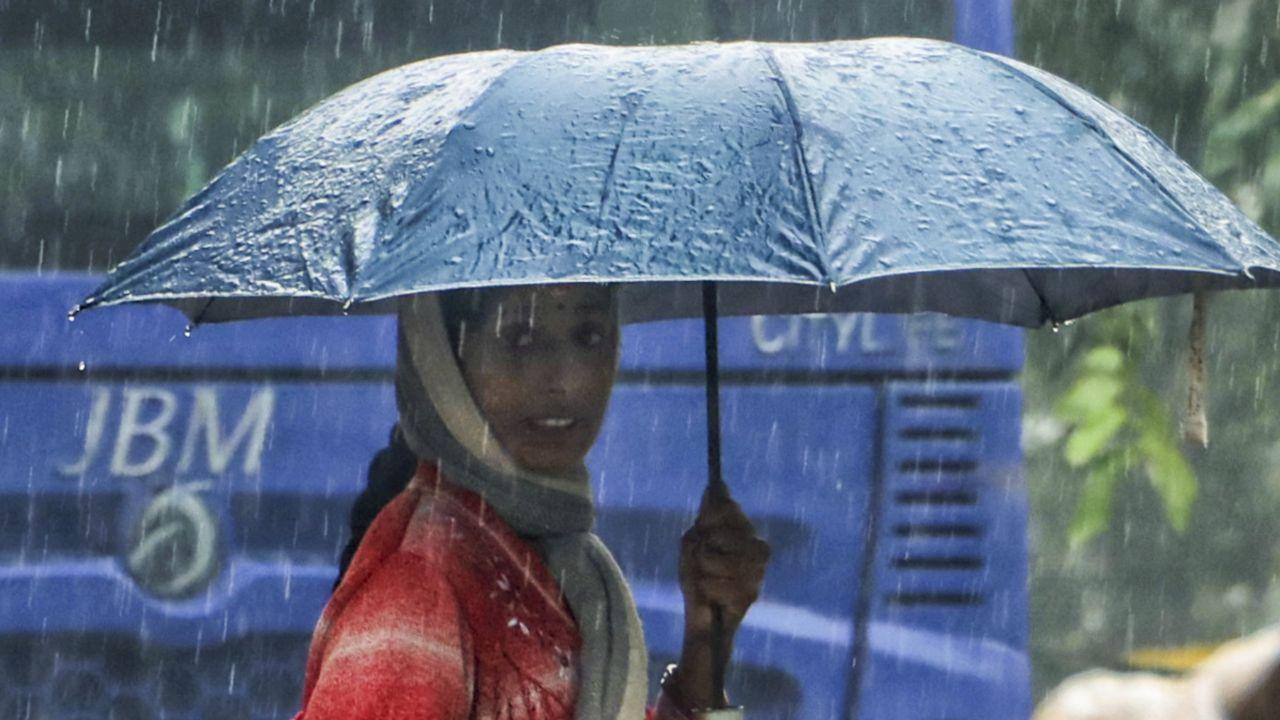 The IMD has forecast cloudy skies and light rain on Tuesday, with the maximum and minimum temperatures expected to settle at 19 and 9 degrees Celsius, respectively. (In Pic: A woman amid rainfall at Jangpura area on a winter morning, in New Delhi on Monday)