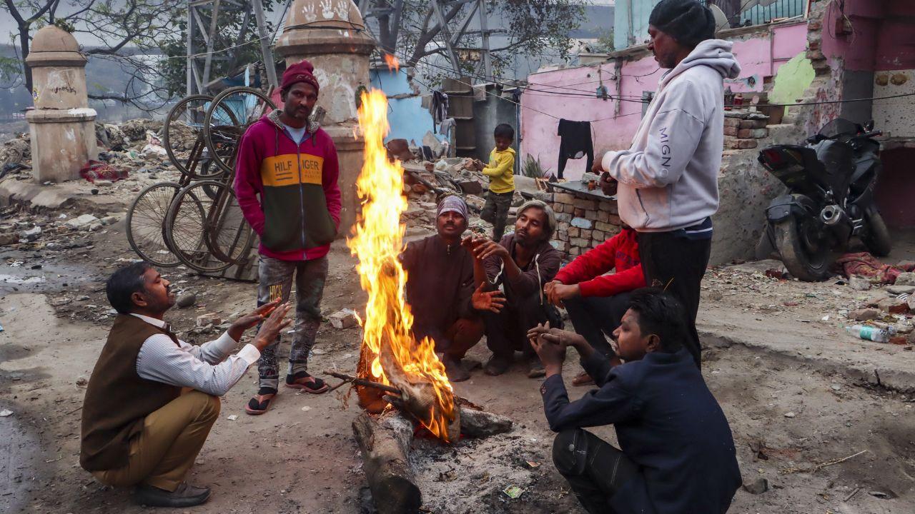 Residents of the national capital were seen gathering bonfires to combat the chill (In Pic: People warm themselves around a bonfire on a winter morning, in New Delhi on Monday)