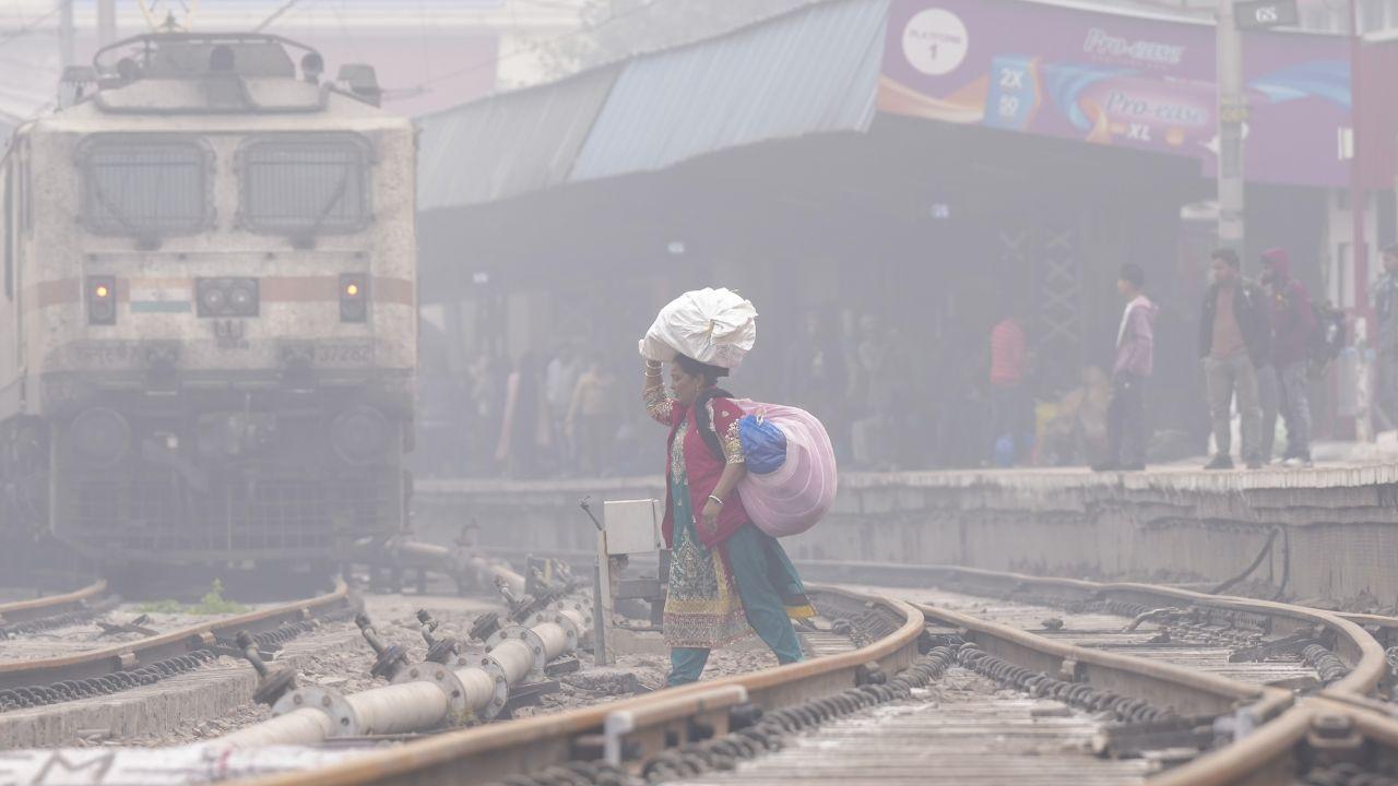 The Air Quality Index (AQI) in the national capital was classified in the 'severe' category on Tuesday, with visibility limited by the fog. (In Pic: A woman crosses railway tracks amid fog on a cold winter day, in New Delhi on Monday)