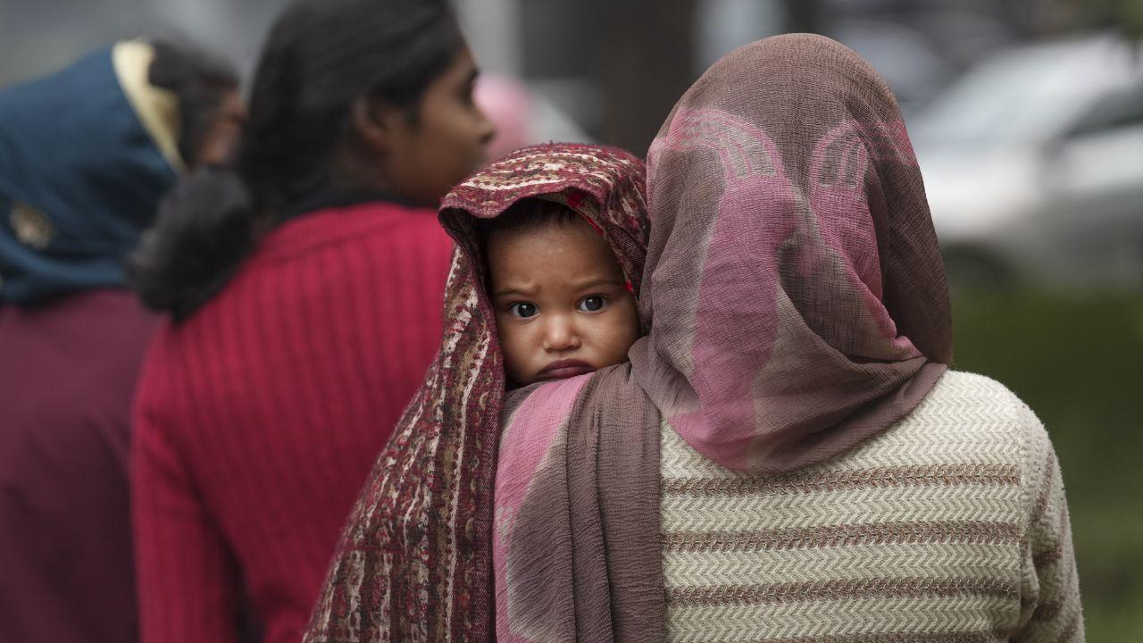 According to the Central Pollution Control Board (CPCB), the AQI was recorded at 401 at 8 AM. (In Pic: A woman holds a child wrapped in warm clothes on a cold winter day, in New Delhi on Monday)
