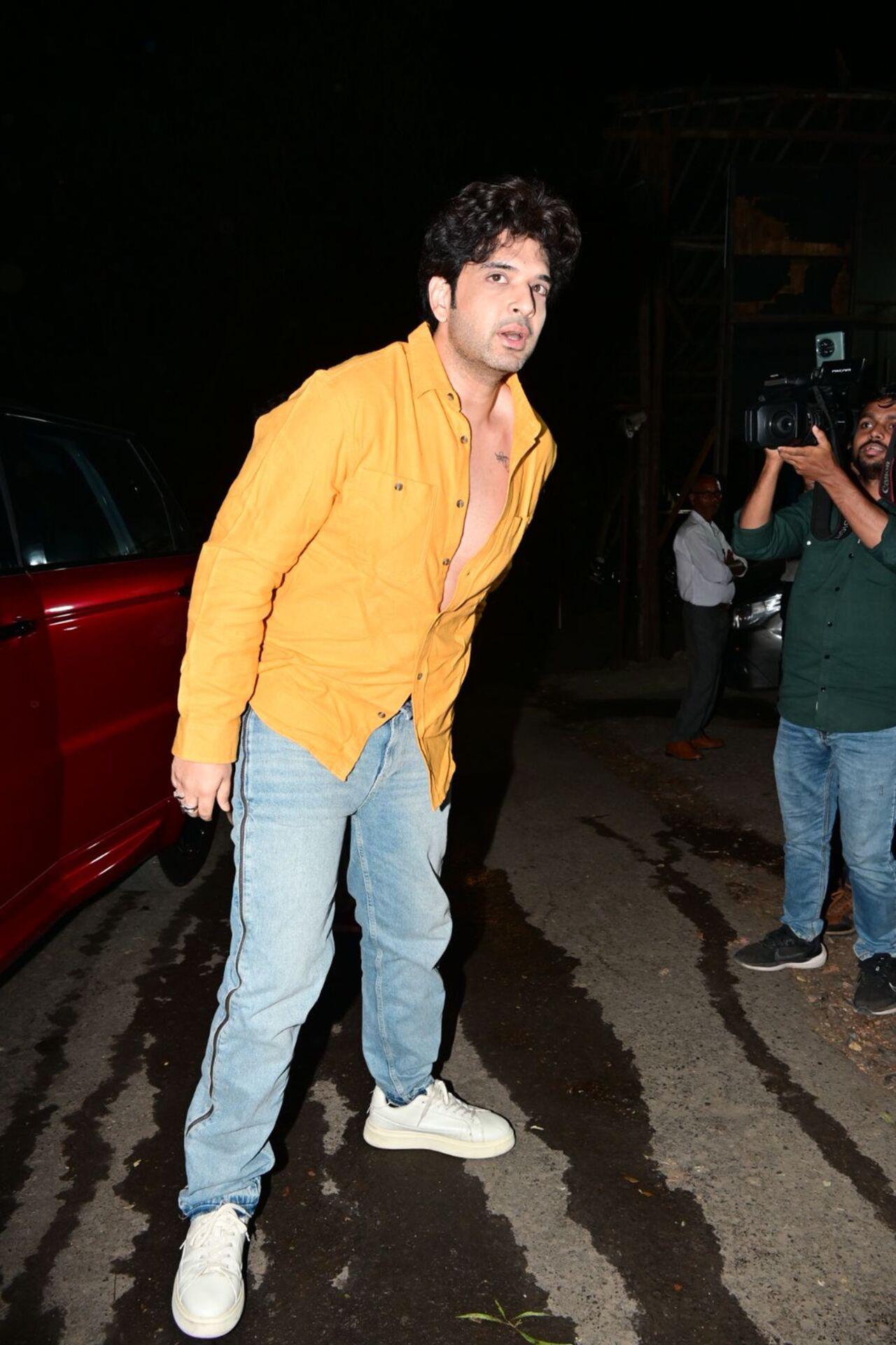 Karan Kundrra commanded attention in a bright orange shirt.