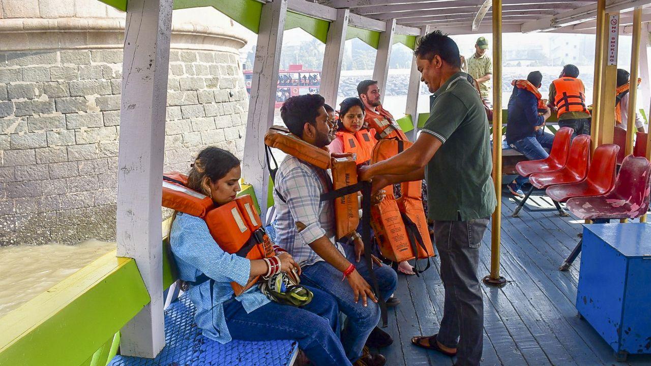 The drivers of some boats who rushed to help the victims were horrified to see chaos at the site with people screaming for help and said they never witnessed such a horrific incident in their lives. (In Pic: A passenger gets assisted to wear a life jacket following the distribution of life jackets to passengers)