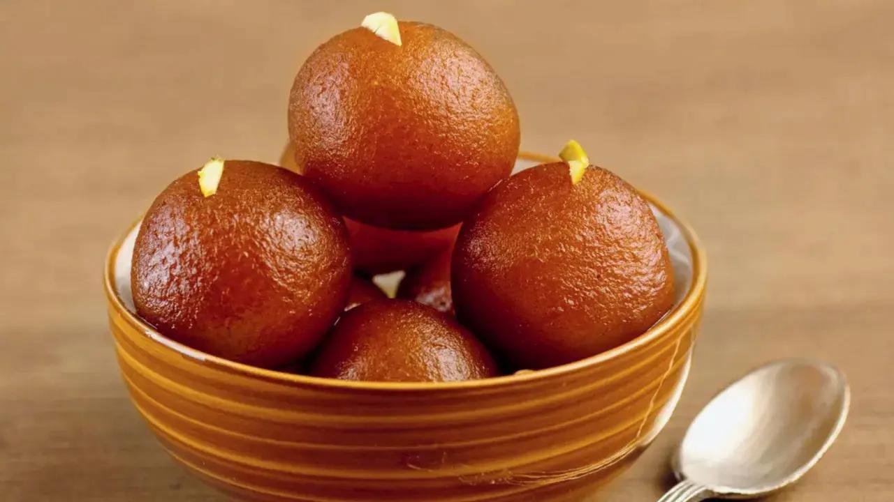 Gulab Jamun is a dessert made from milk solids that are kneaded into a dough, shaped into balls, and deep-fried. The fried balls are then soaked in a sugary syrup and sometimes garnished with saffron, green cardamom, or rose water