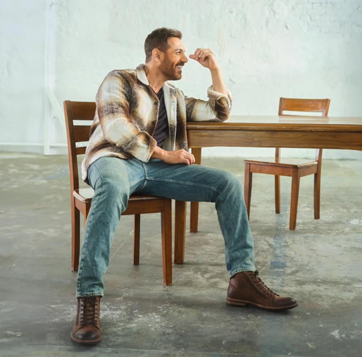 John Abraham looks dapper in this outfit as he pairs blue denim with tan cowboy shoes and completes the look with an ombre brown and white jacket.