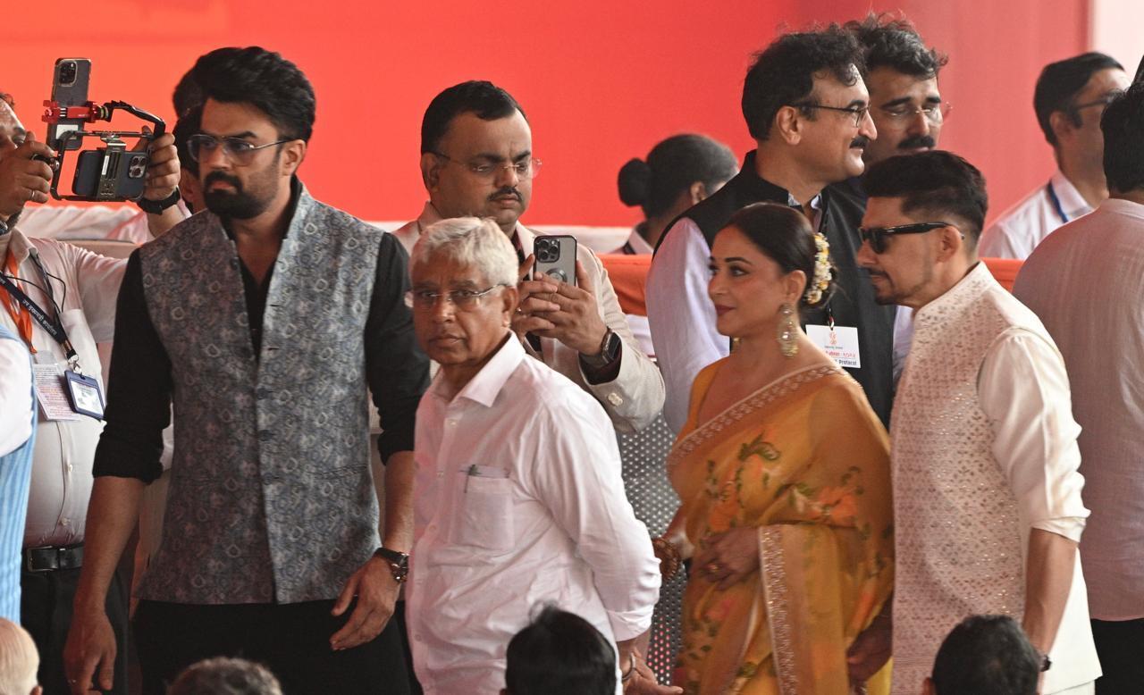 Madhuri Dixit looked bespoke in a yellow saree as she arrived with her husband Shriram Nene. 
