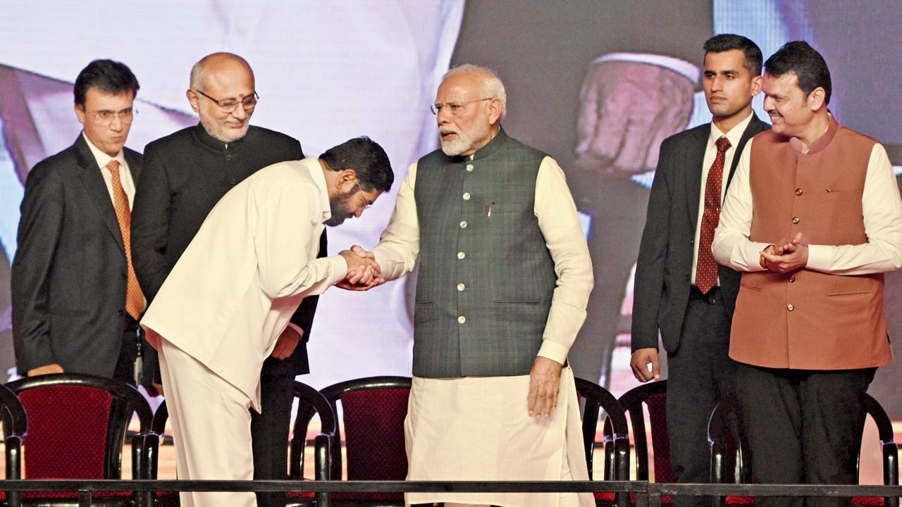 Eknath Shinde greets the prime minister after taking oath as deputy chief minister