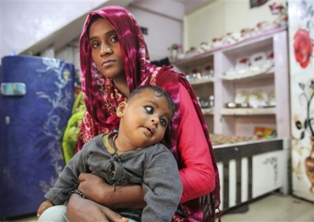 A woman with her child, born with congenital disabilities, believed to be caused by the child's grandparents' exposure to gas leakage during the 1984 Bhopal gas tragedy.