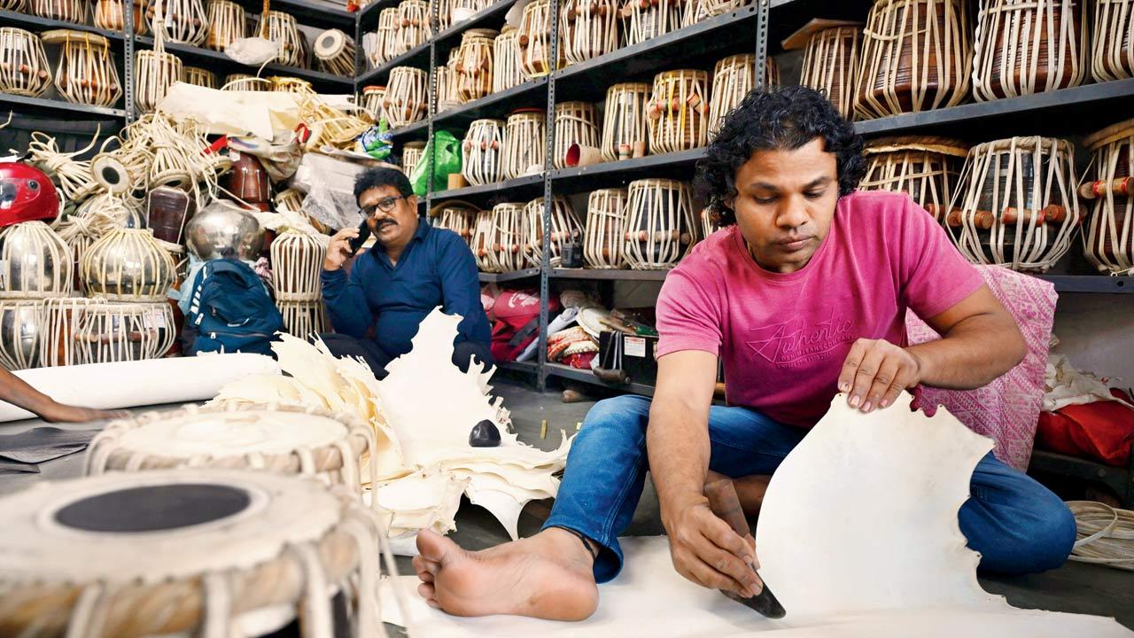 Haridas Vhatkar’s son Kishor cuts out a tabla top at his workshop in Kanjurmarg; the former was Ustad Zakir Hussian’s official tabla maker. Pic/Kirti Surve Parade