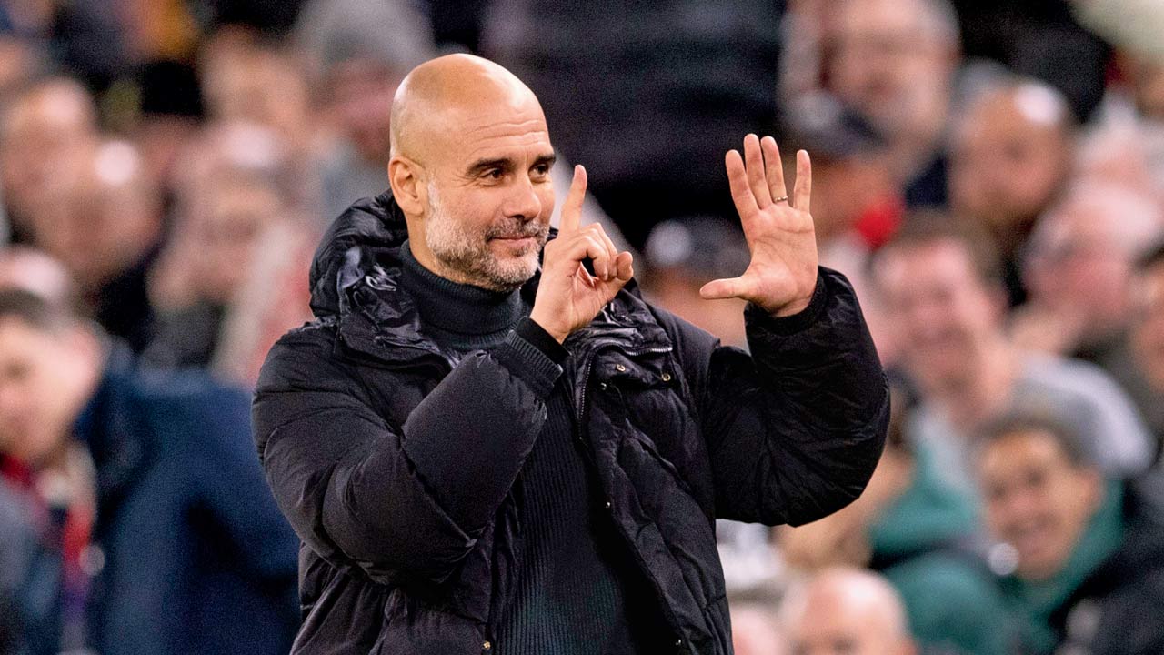 Man City boss Pep Guardiola shows six fingers indicating six titles to taunting Liverpool fans. Pic/Getty Images