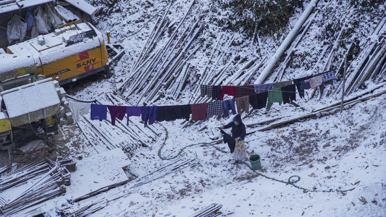 Shimla received 2.5 cm of snow, and areas like The Ridge, Mall Road and Jakhoo Peak were covered in a light blanket of snow. (In Pic: A woman dries clothes in sun after fresh snowfall in Shimla, Himachal Pradesh on Monday)
