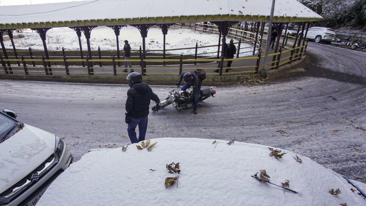 Snow and slippery road conditions also disrupted vehicular traffic on several roads in the upper Shimla region. (In Pic: A biker falls on a slippery road after fresh snowfall in Shimla, Himachal Pradesh, Monday)