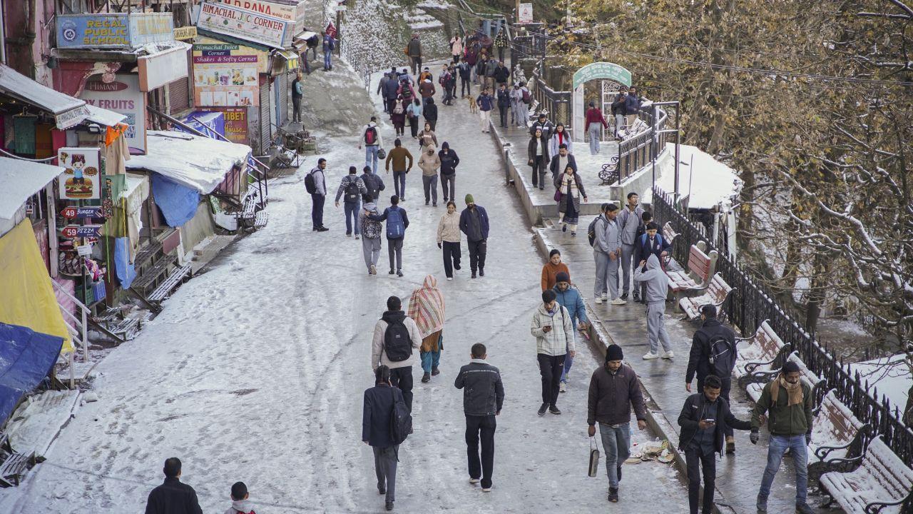 A total of 58 roads were closed in Shimla, followed by 17 in Kinnaur, six in Kangra, two in Lahaul and Spiti, one each in Kullu and Chamba districts. Some parts of Himachal suffered power outrages as 457 transformers were disrupted, the SEOC said. (In Pic: People walk on a snow covered road after fresh snowfall in Shimla, Himachal Pradesh)