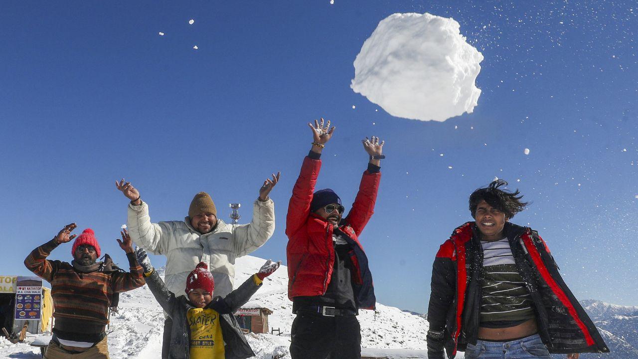 Tourists enjoy after fresh snowfall, at Patnitop hill station, Jammu & Kashmir. (Pic/ PTI)