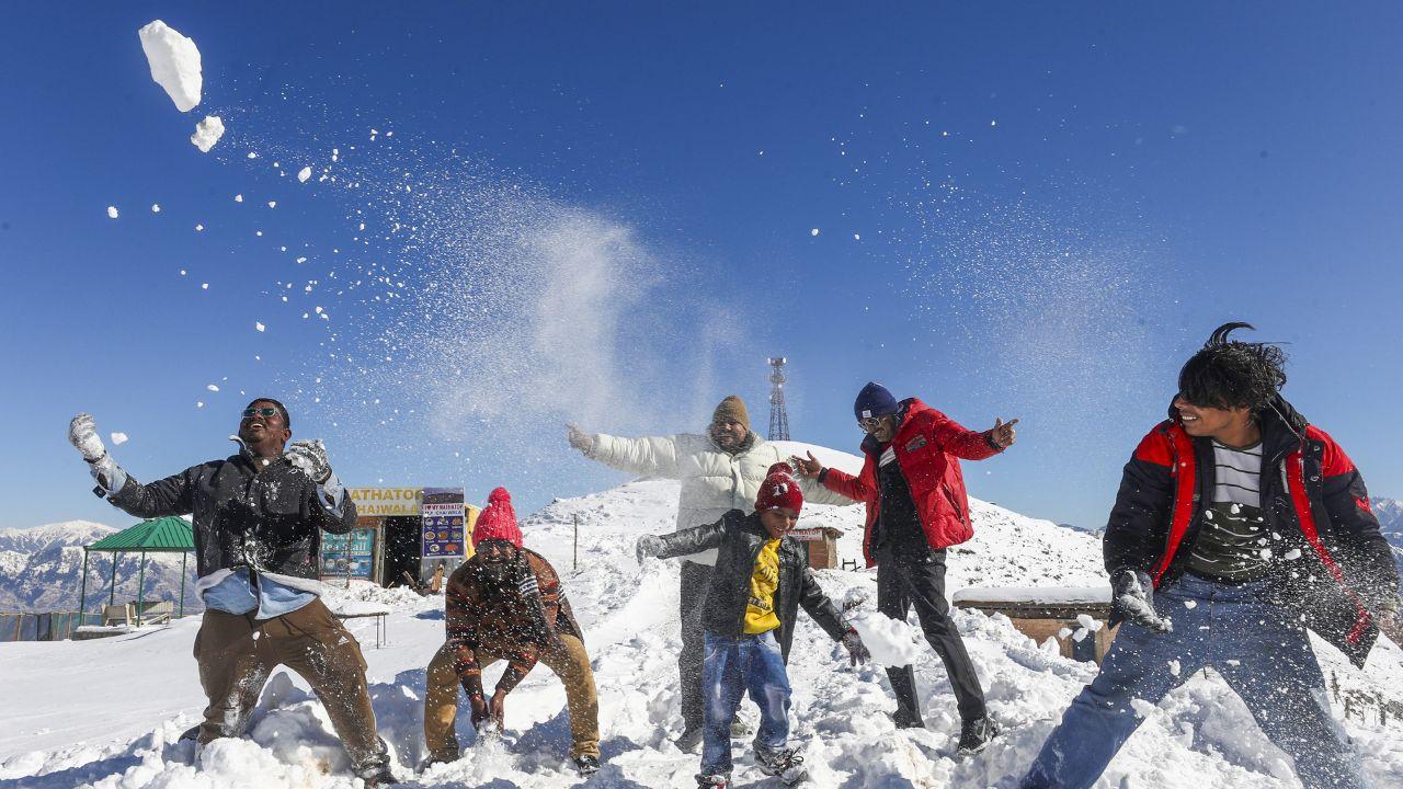 Tourists enjoy after fresh snowfall, at Patnitop hill station in Udhampur district. (Pic/ PTI)