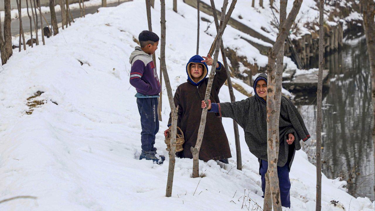 Children enjoy after heavy snowfall, on the outskirts of Srinagar. (Pic/ PTI)