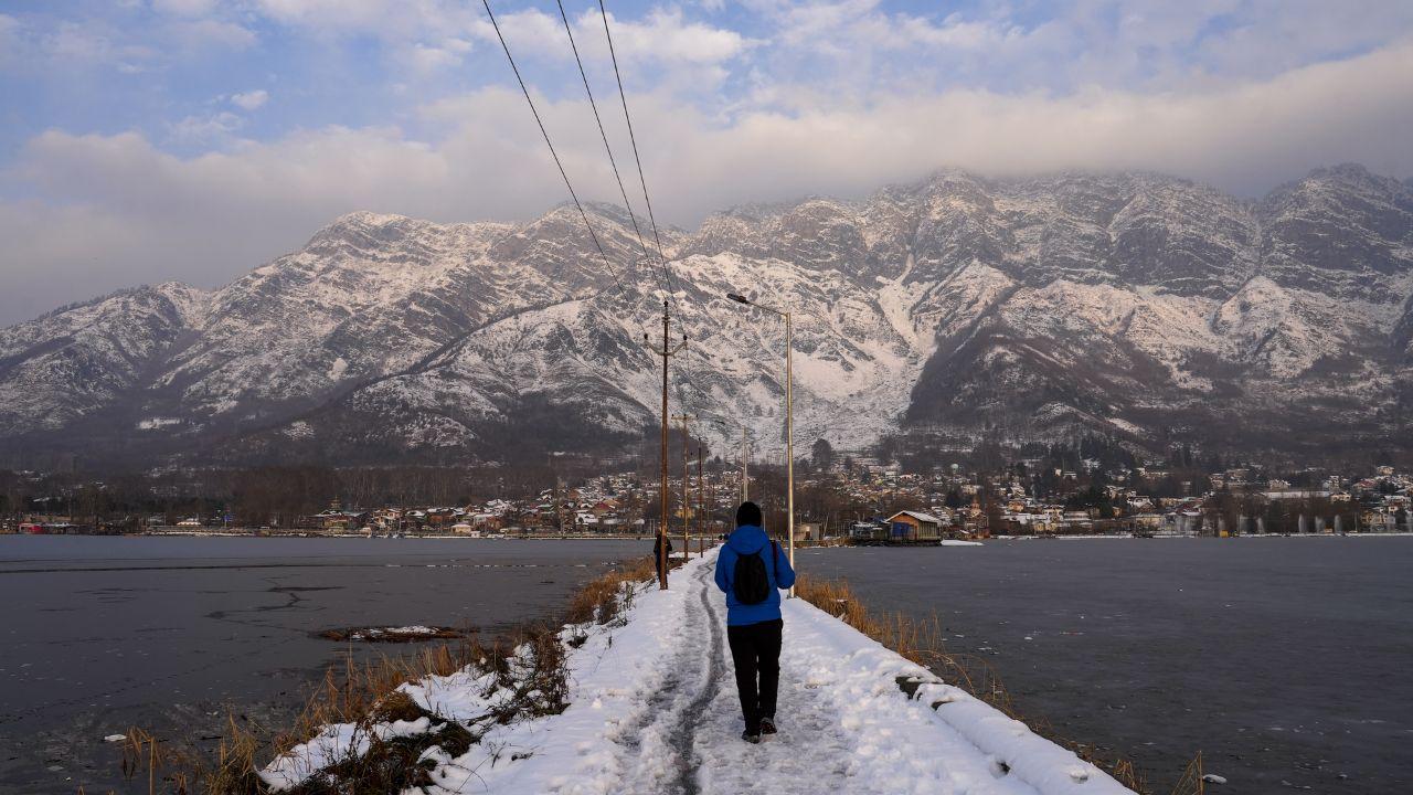 A man walks through a snow covered path after snowfall, in Srinagar. (Pic/ PTI)