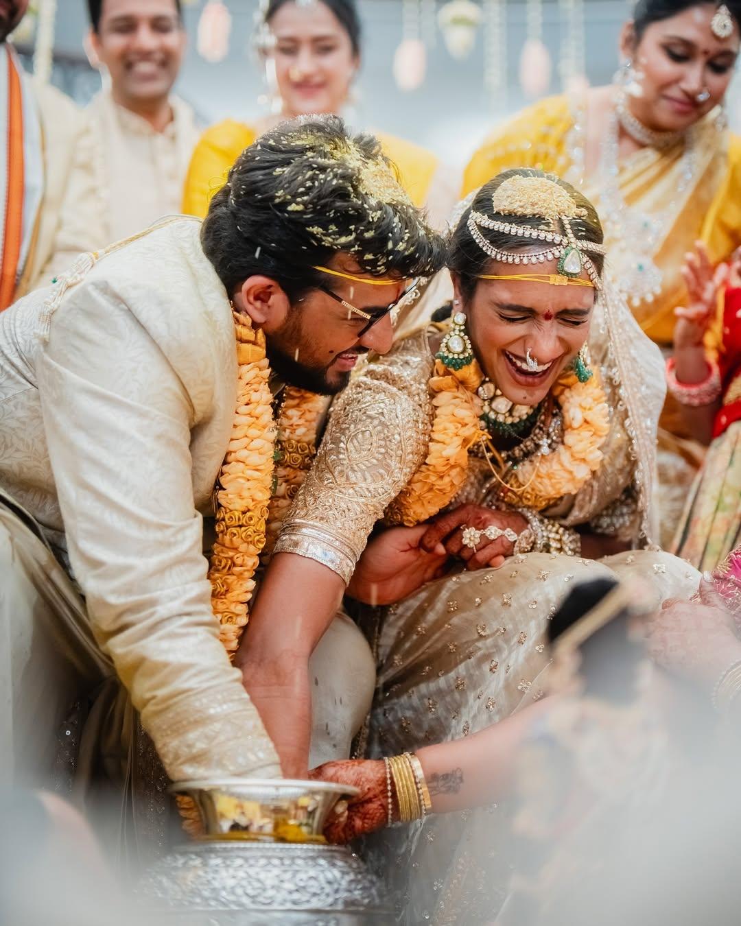 The next picture shows the duo performing a wedding ritual, where they both can be seen trying to retrieve something from the kalash