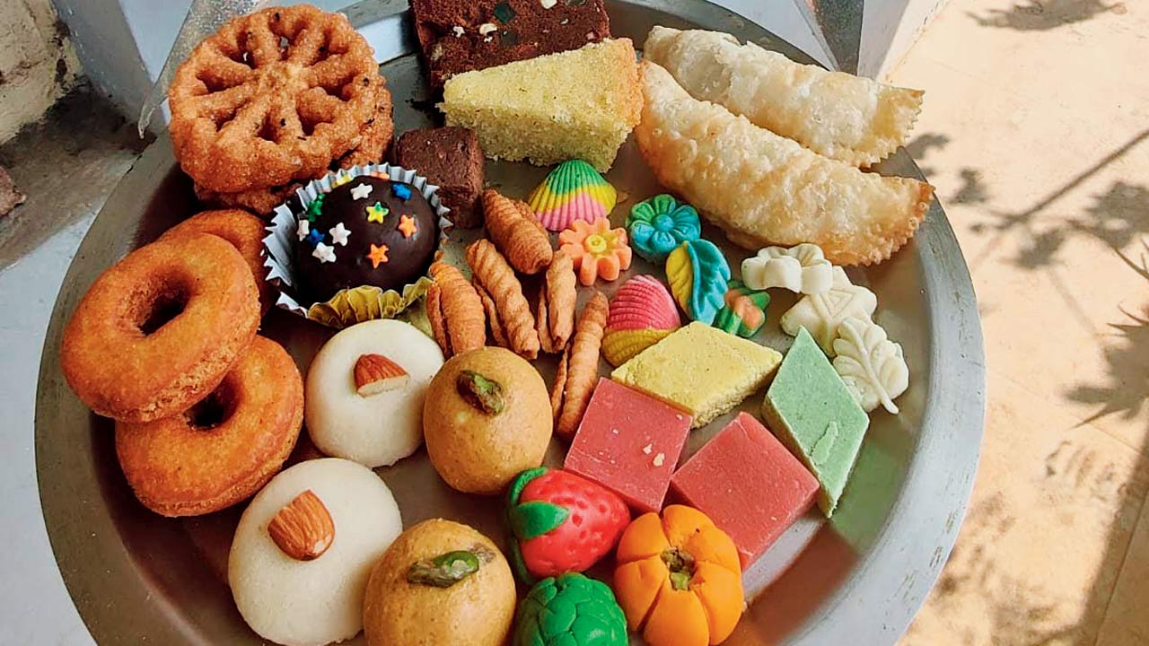 A platter of East Indian sweets like nancatai (biscuits), peru halwa  (guava jelly), shingoli (nevris), marzipan and kulkul