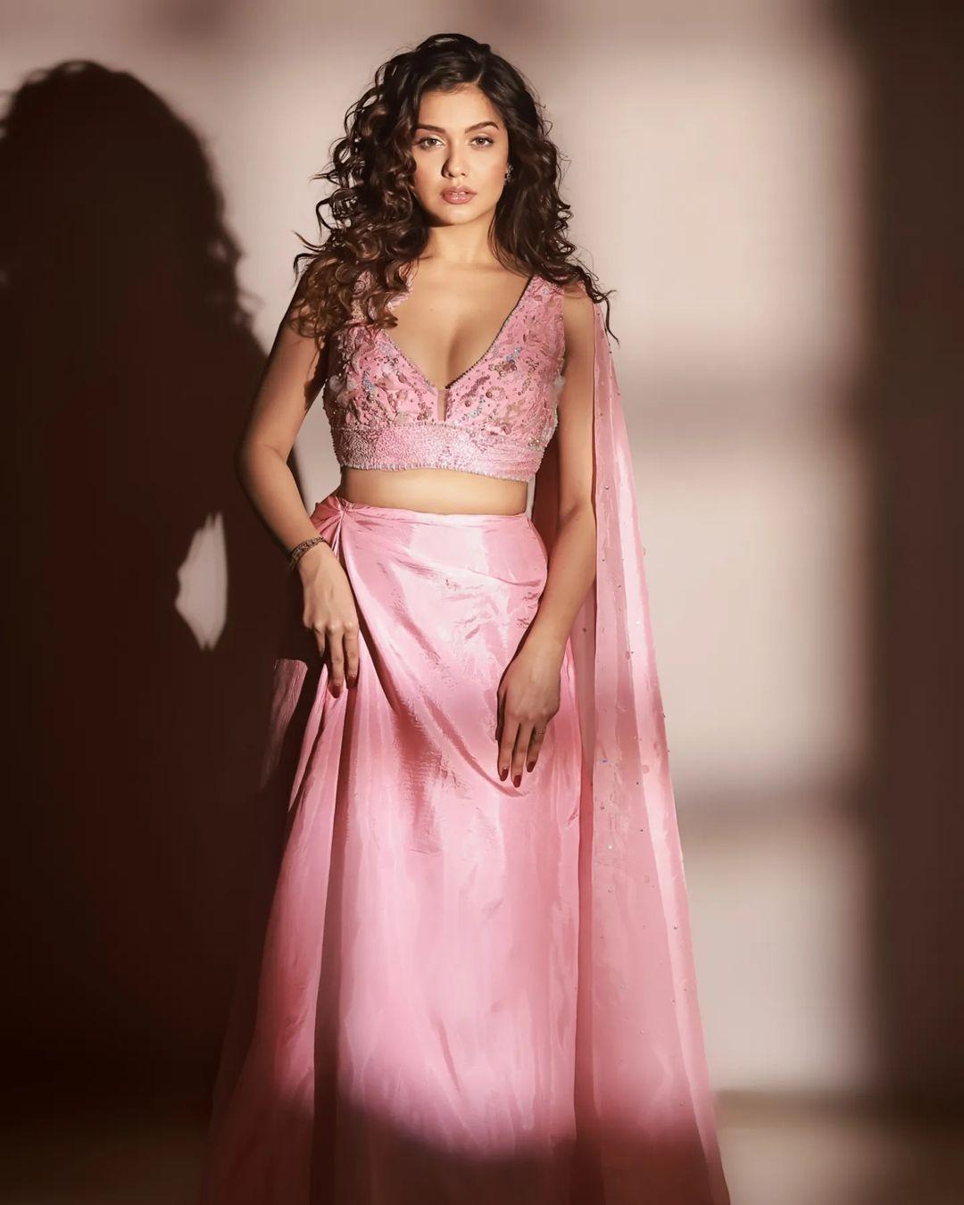 Notably, the lehenga is adorned with a sizable matching trail, adding a touch of grandeur. Divya left her hair open in deep curls and opted for nude makeup, creating an ethereal appearance